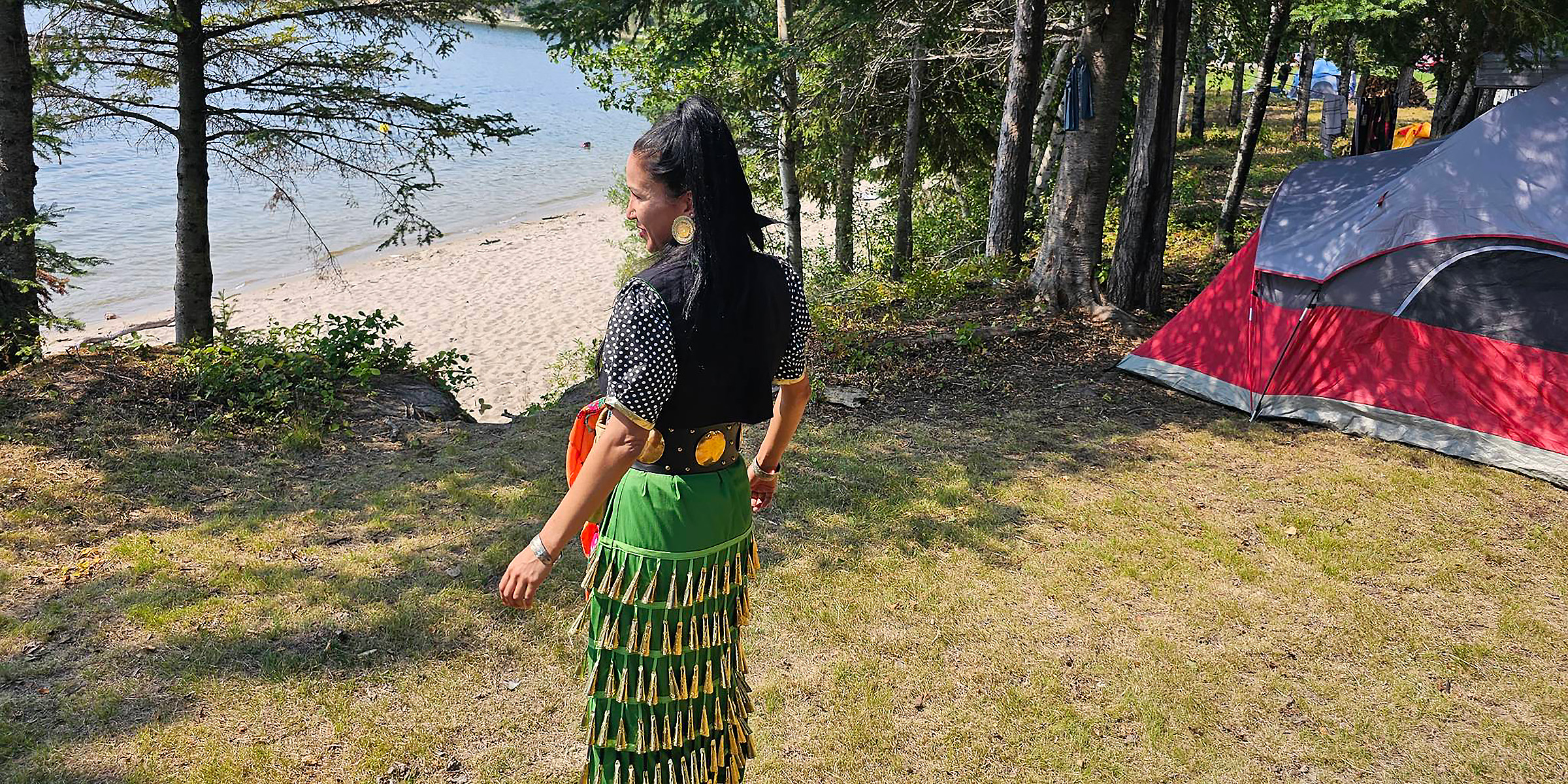 An Indigenous woman staring out at a lake