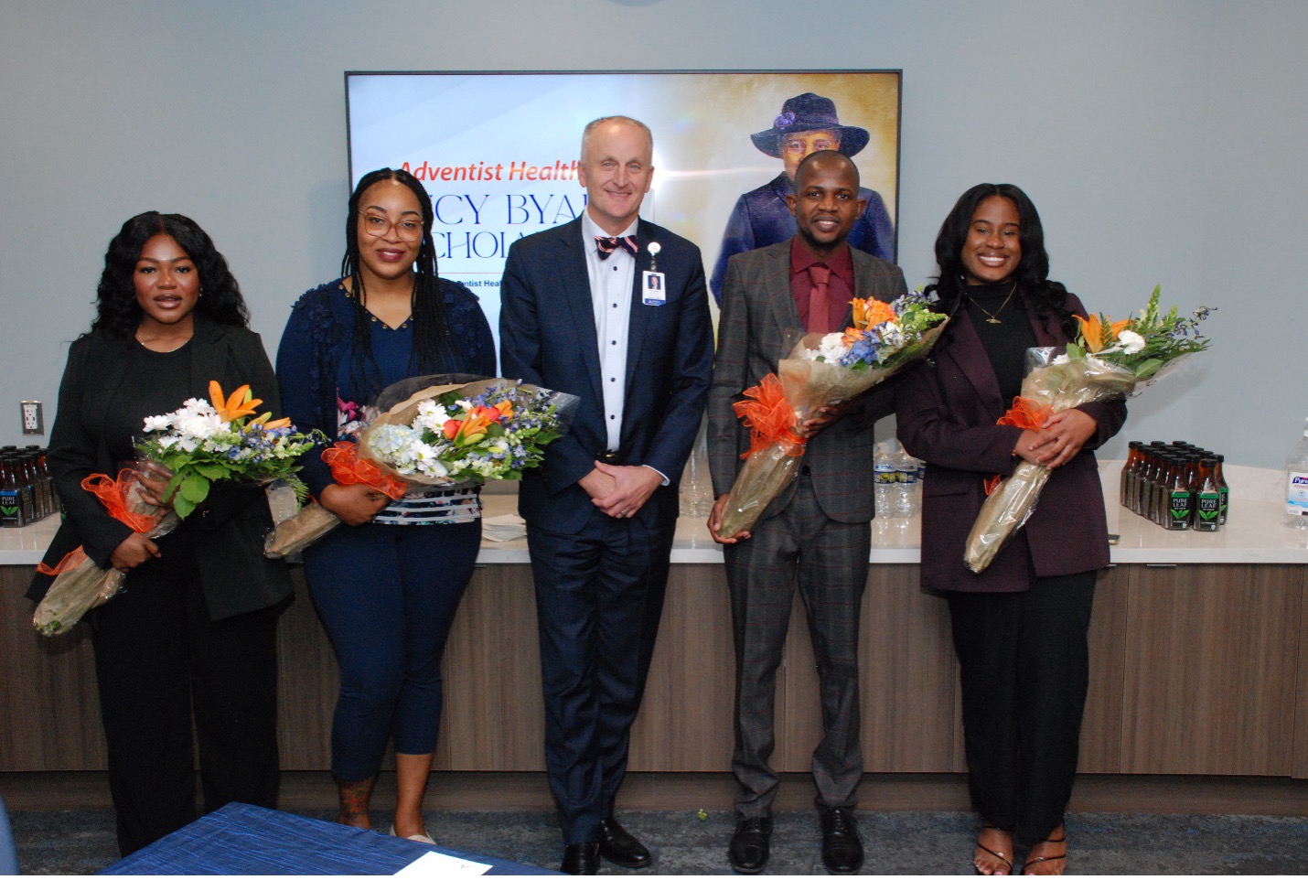 Adventist HealthCare President and CEO Terry Forde (center) congratulates the 2023 Lucy Byard Scholarship Award winners (left to right), Victoria Ofori (Howard University), Cameca Anderson (Washington Adventist University), Junior Philogene (Howard University), and Tianna Lawrence (Howard University).