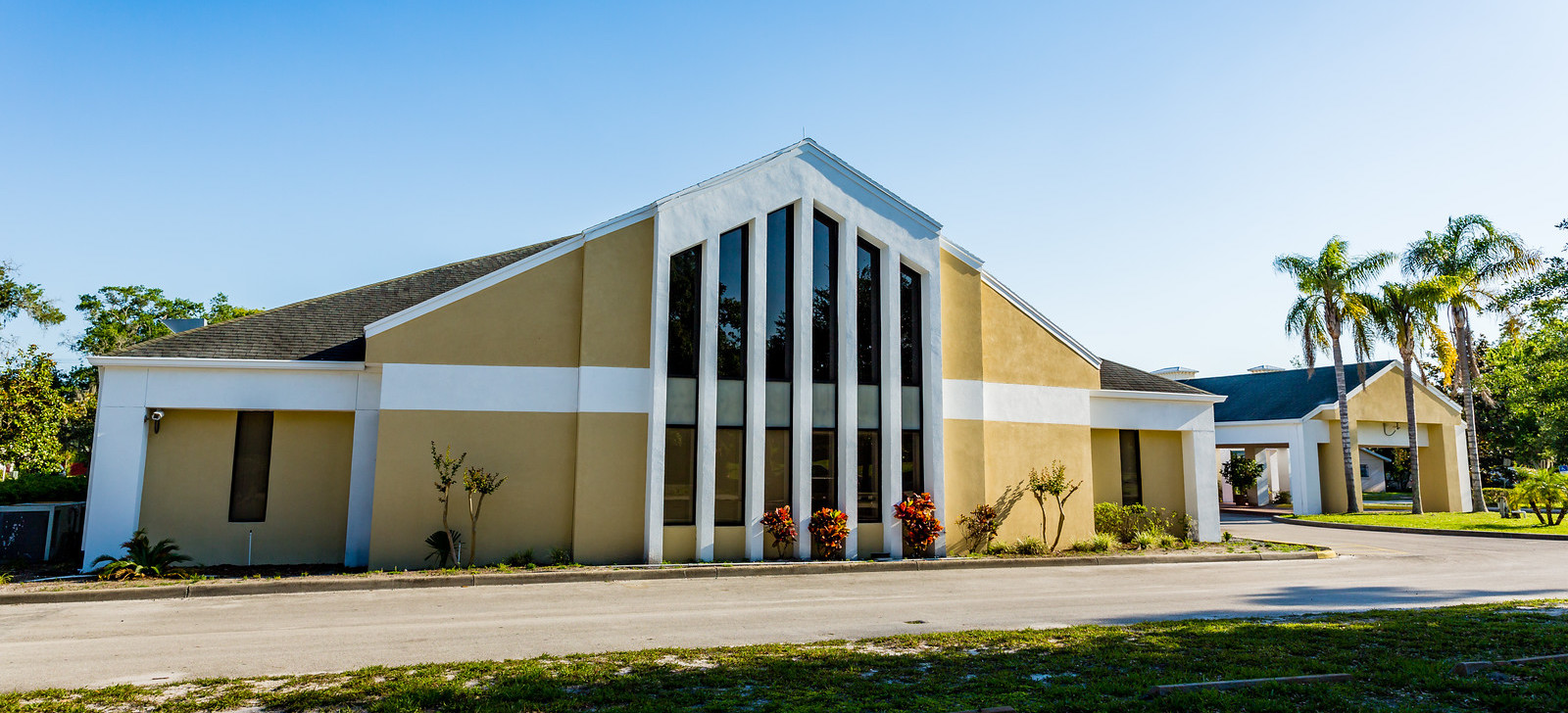 Photo of the outside of a yellow church building