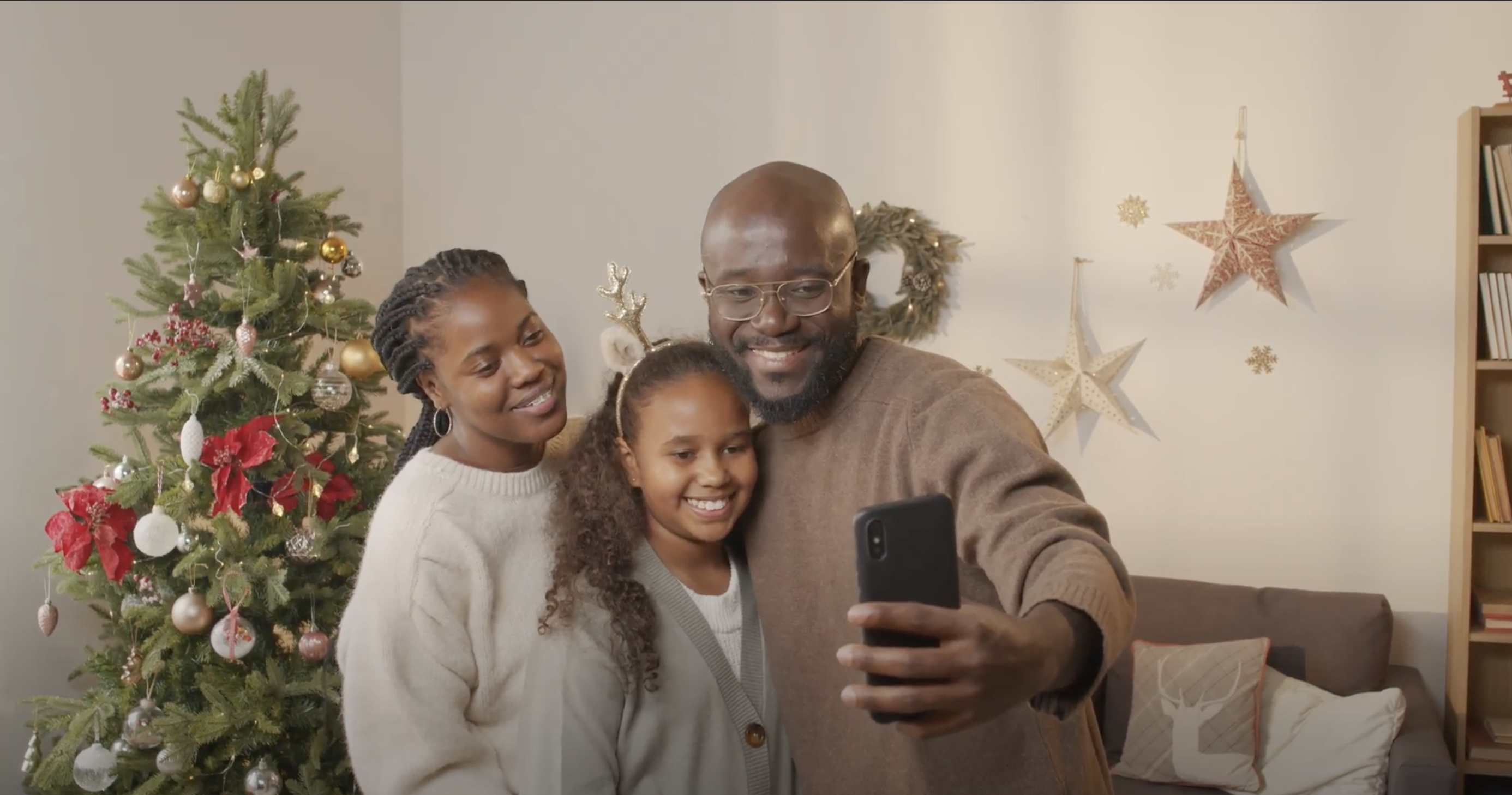 Screenshot of family at the holidays taking a family selfie picture