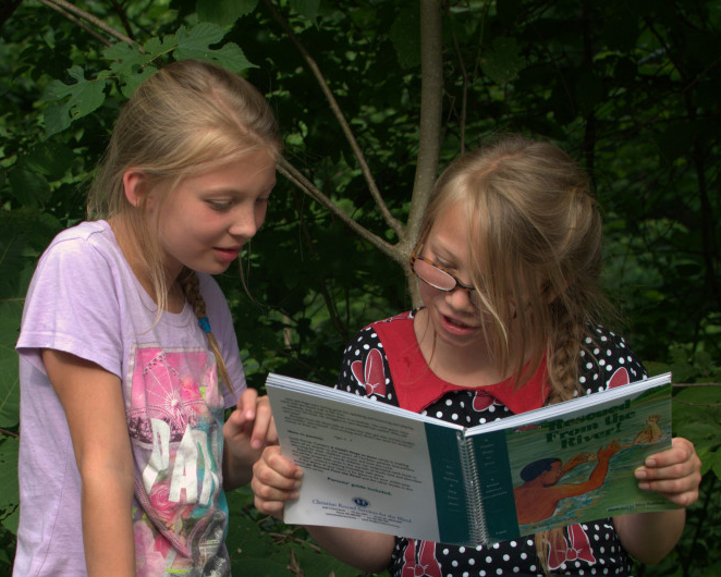 CRS Fiona reads large print book to sighted sister