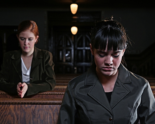 stock photo two women praying in church