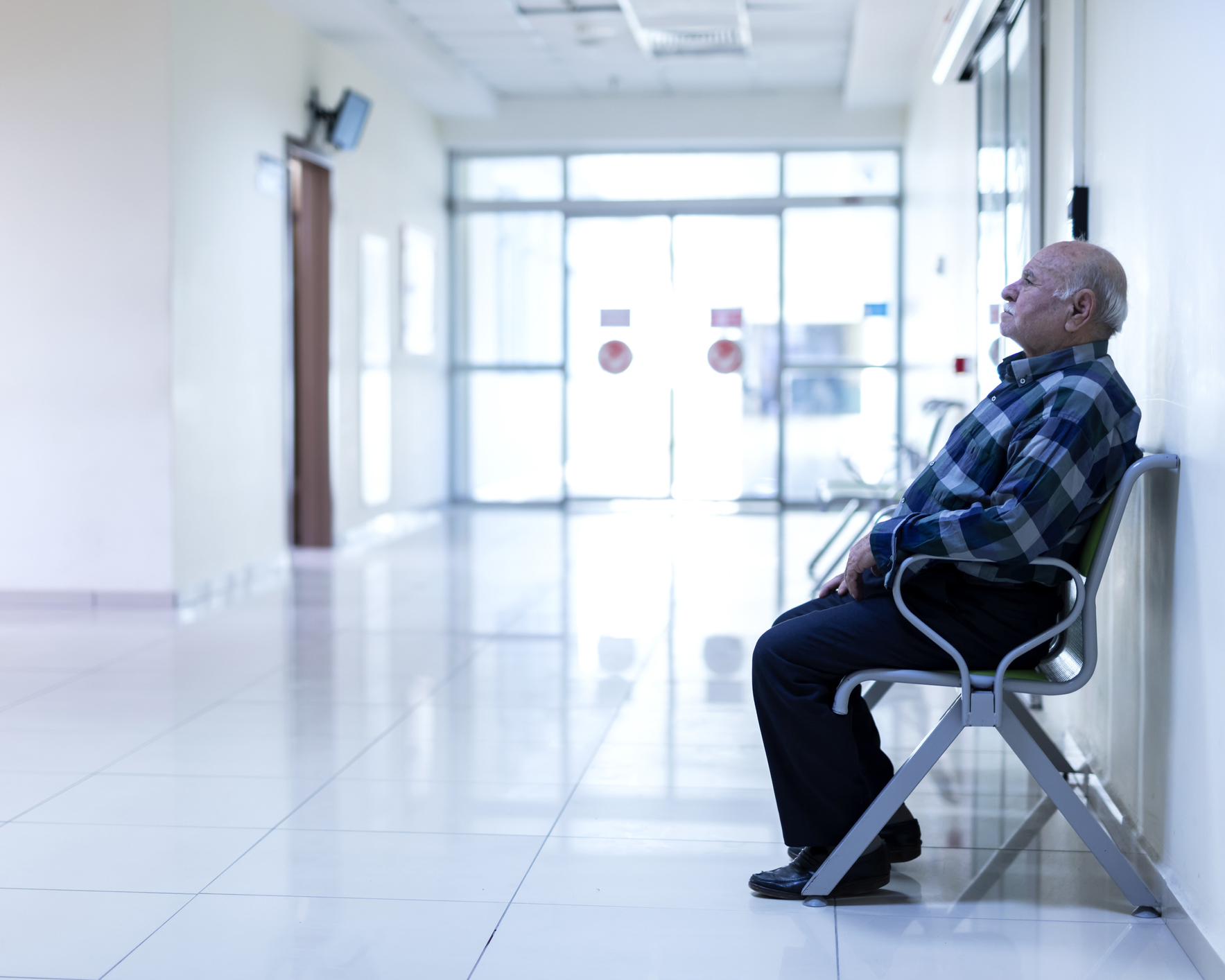 stock photo of older man in hospital waiting area