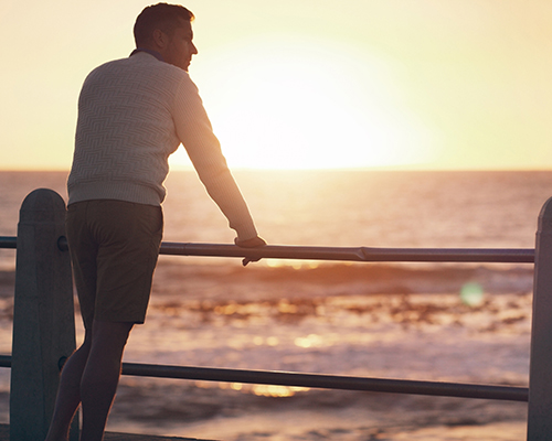 stock photo of man looking out at ocean