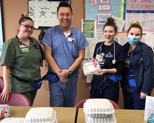 Healthcare workers with meals purchased by Adventist ministries