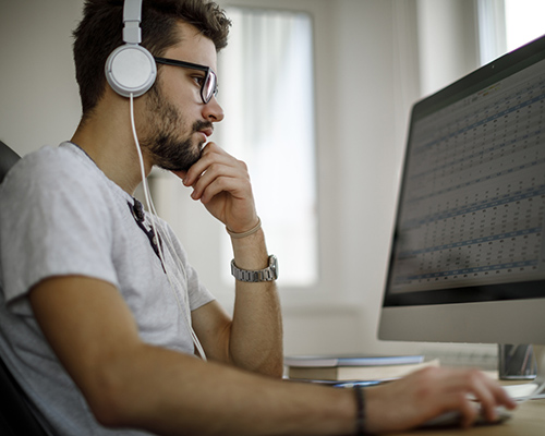 stock photo of male college student at computer