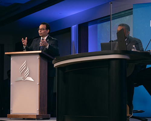 Middle-aged man standing at podium