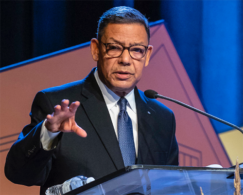 Juan R. Prestol-Puesán speaking at a podium