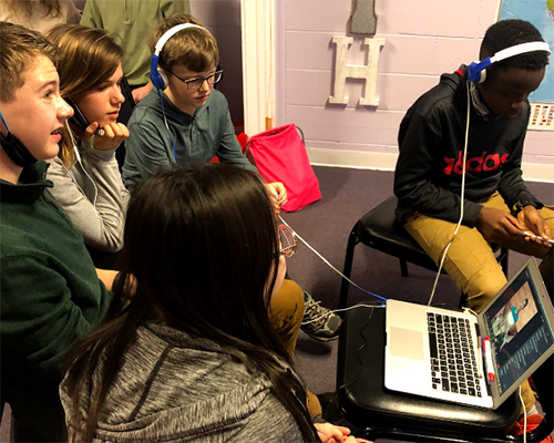 Teenagers looking at a laptop