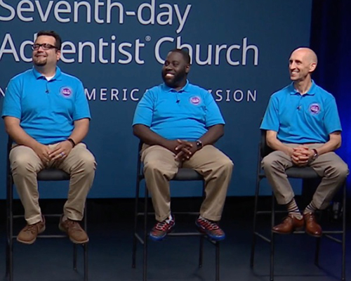 Armando Miranda, Vandeon Griffin, and Tracy Woods sitting on stools on a stage