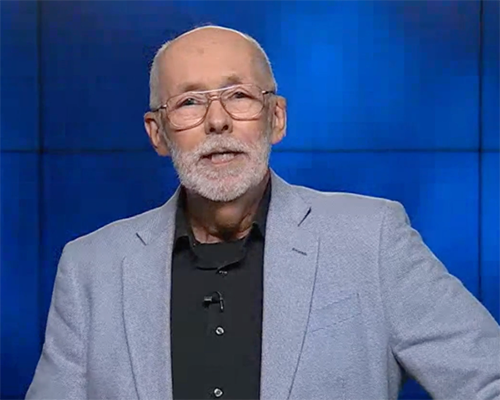 Elderly man speaking at a podium