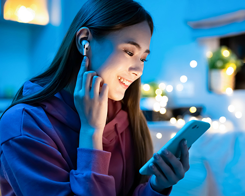 stock photo Asian woman listening to podcast