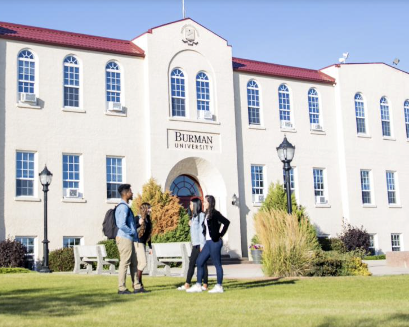 student talking at front of a building