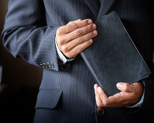 stock photo of man in suit with Bible