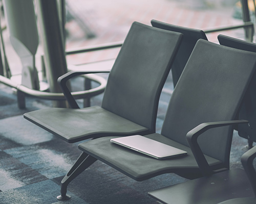 stock photo of laptop on airport seat