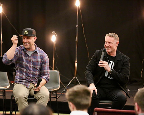 Pastor Ben Lundquist (left) and Dan Linrud, Oregon Conference president, have a conversation with young adults at the second annual "Dinner With Dan" event on April 8, 2023.