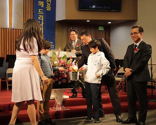 group of people smiling at a church alter