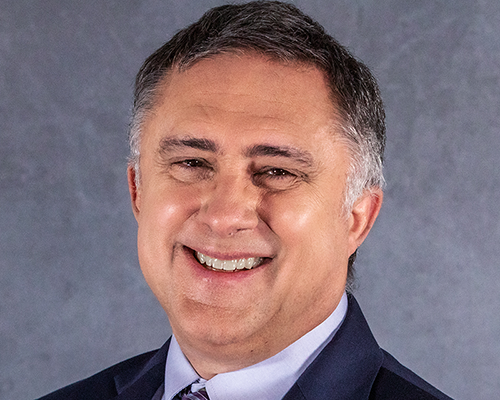 Photo of smiling white man with salt and pepper hair