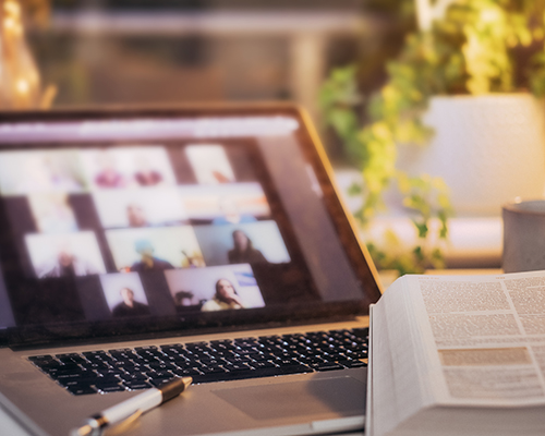 stock photo of computer Zoom-type meeting and Bible