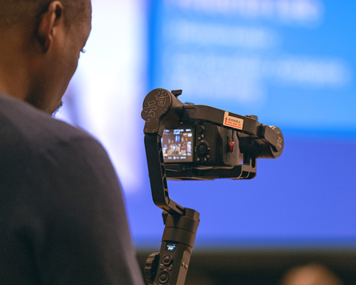 Close up of young man using a video camera at the 2023 SAC convention