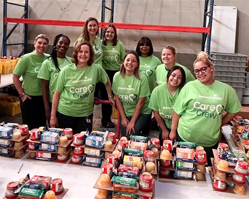 AdventHealth volunteers set up food supplies for kids' lunches