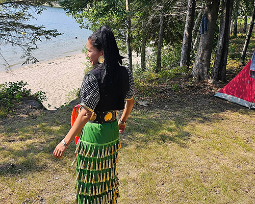 An Indigenous woman staring out at a lake