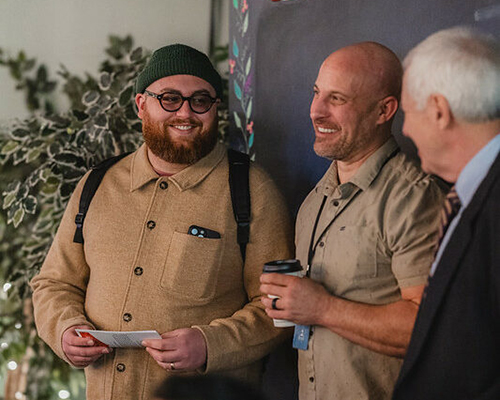 Young Adult LIFE Tour speaker Benjamin Lundquist (middle age caucasian man) holds a multigenerational conversation with two attendees