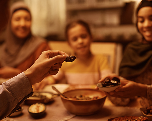 Stock photo of family eating meal at Ramadan