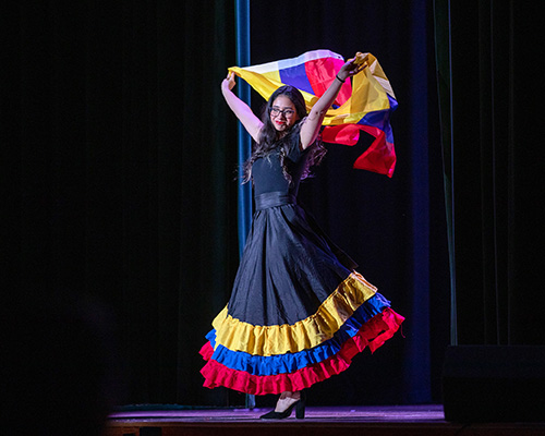 Student displaying cultural clothing at Latin night event