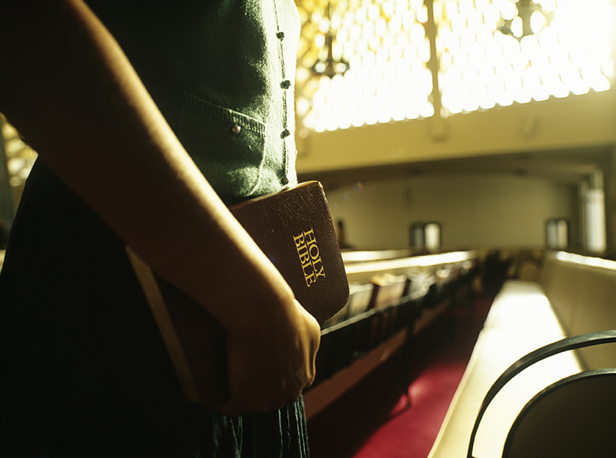 Holding Bible in Church