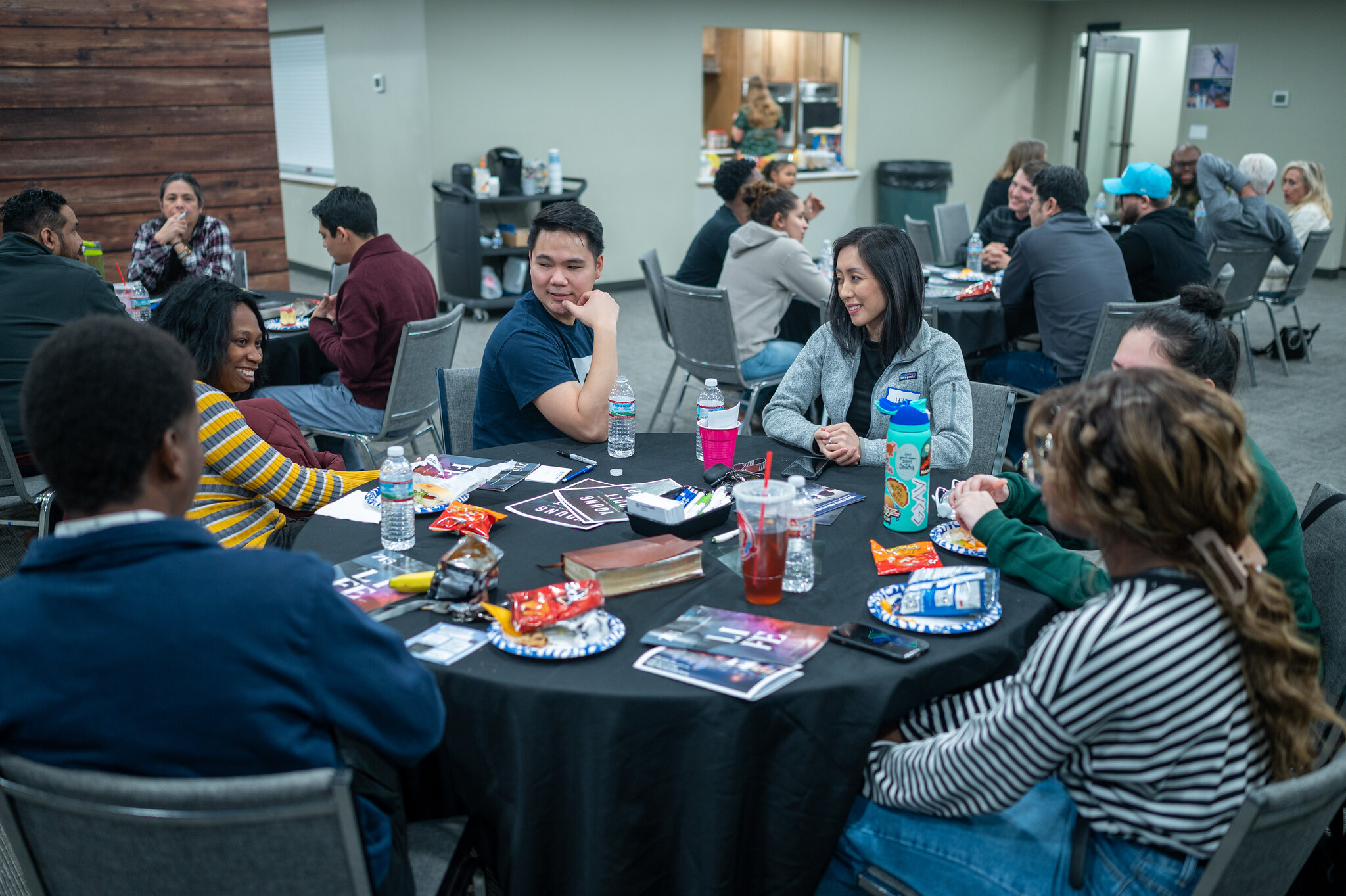 Young people sitting around a round table laden with training materials