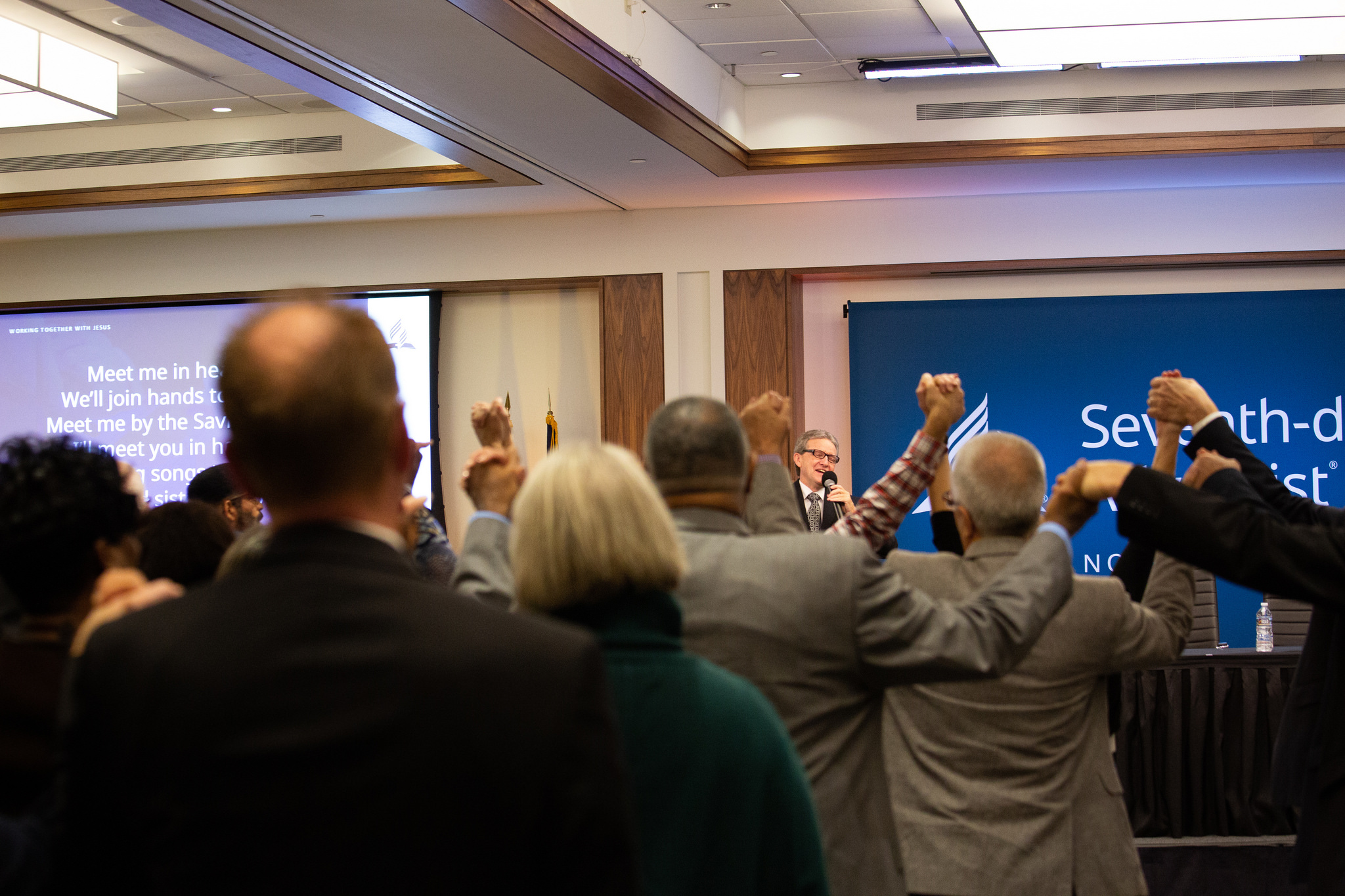 Before the second business session of the 2018 NAD Year-End Meeting, the delegates sing "Side By Side," a popular song written by Adventist Jeff Wood, writer, film director/producer, who recently passed away. Photo by Mylon Medley