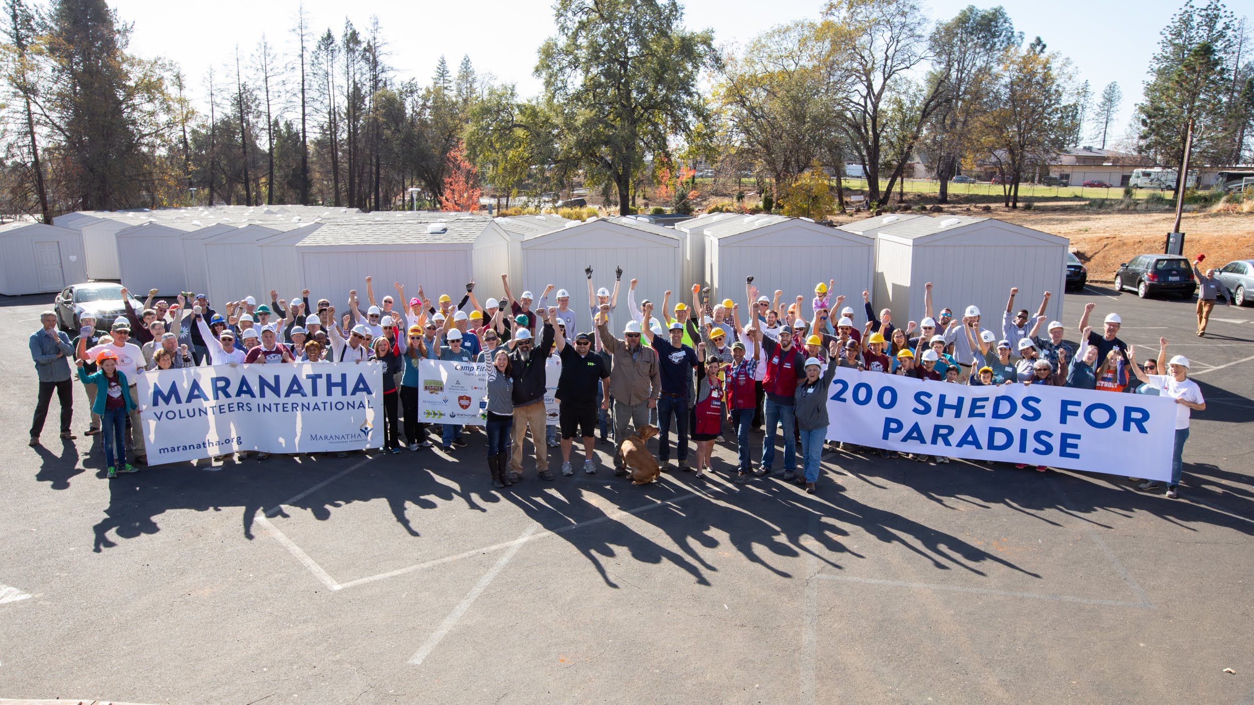 Volunteer builders celebrate the completion of more than 200 storage sheds for Paradise, California, residents who lost their homes in the 2018 Camp Fire. Photo by Tom Lloyd