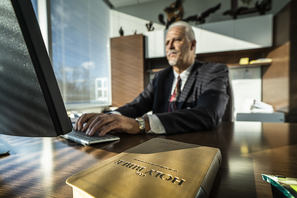 Randy Robinson works at his office desk; photo by Dan Weber