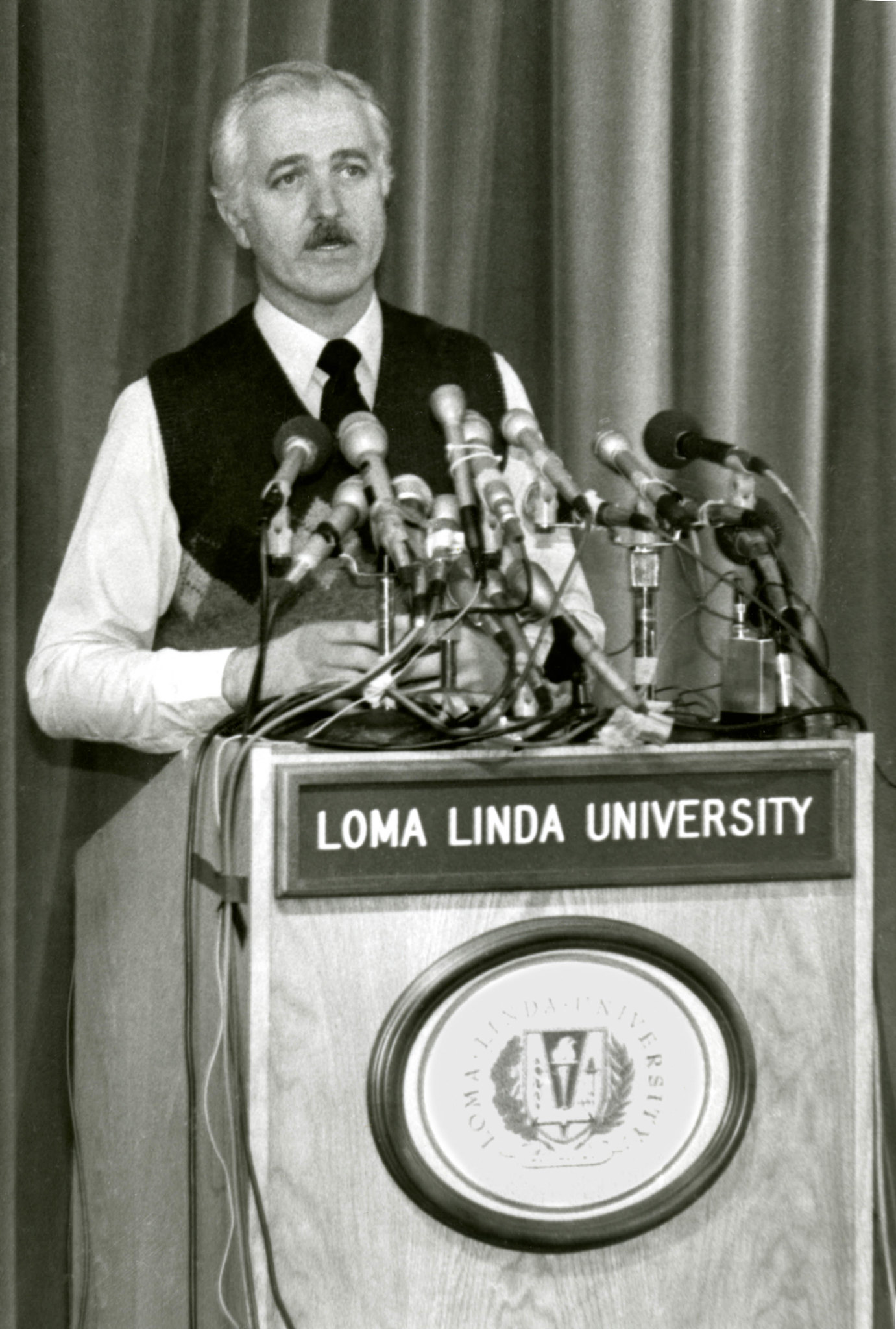 Leonard Bailey, MD, regularly addressed the news media throughout the Baby Fae post-op care. Fae's surgery was one of the world's biggest news stories of 1984.