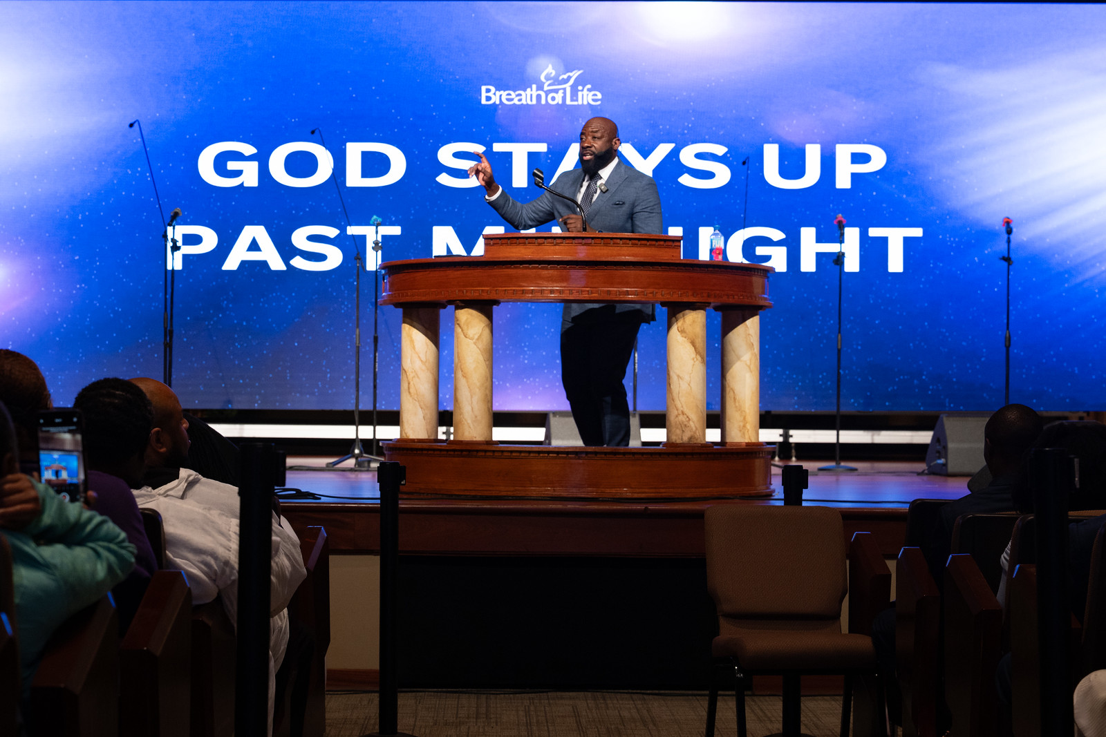 Elder Snell preaches on stage.