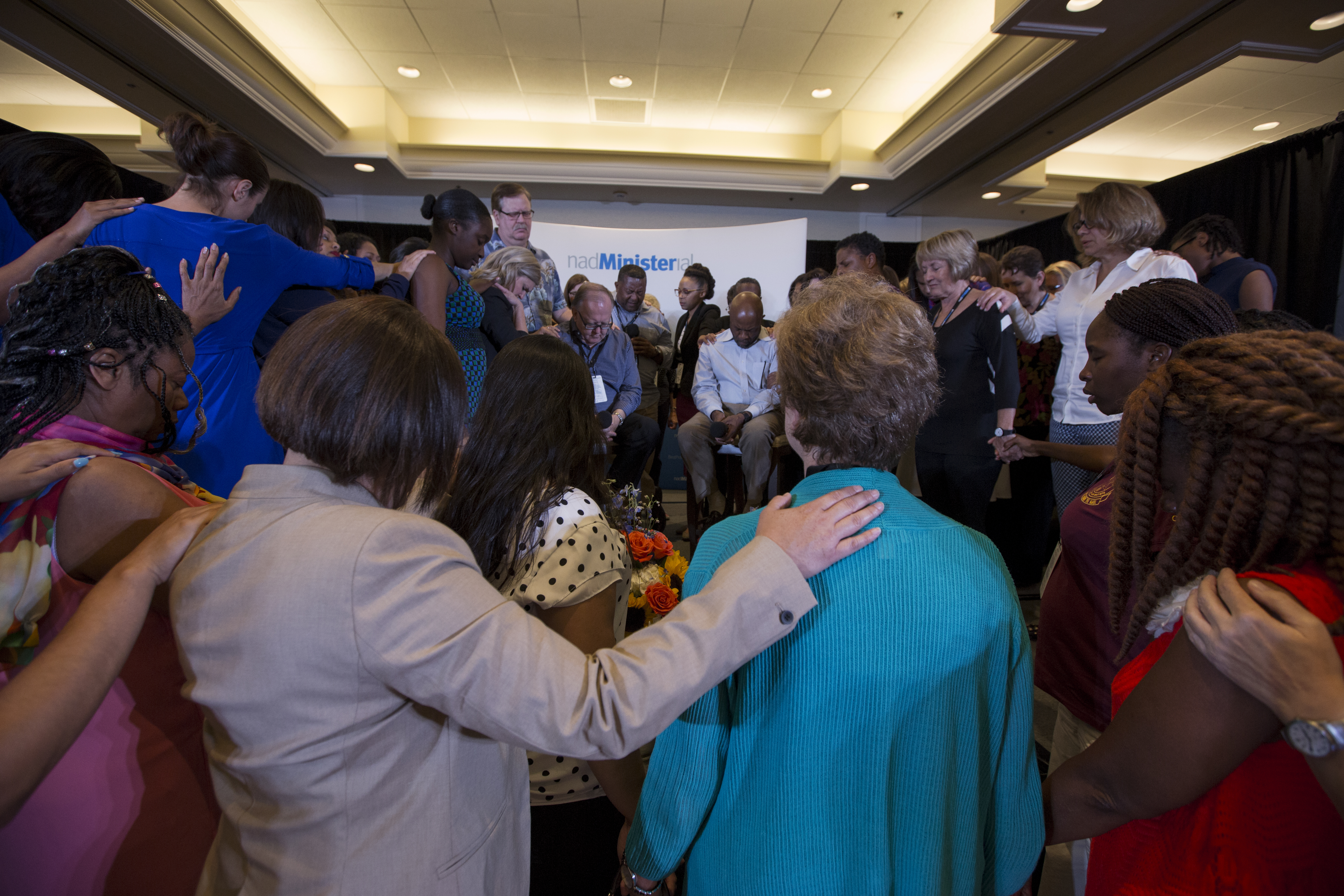 At the end of the Q&A with the president and executive secretary of NAD, Dan Jackson and Alex Bryant, the director of NAD Ministerial, Ivan Williams said a prayer over the two men. One-by-one the women clergy moved to the front of the room during the prayer to surround the leaders.
