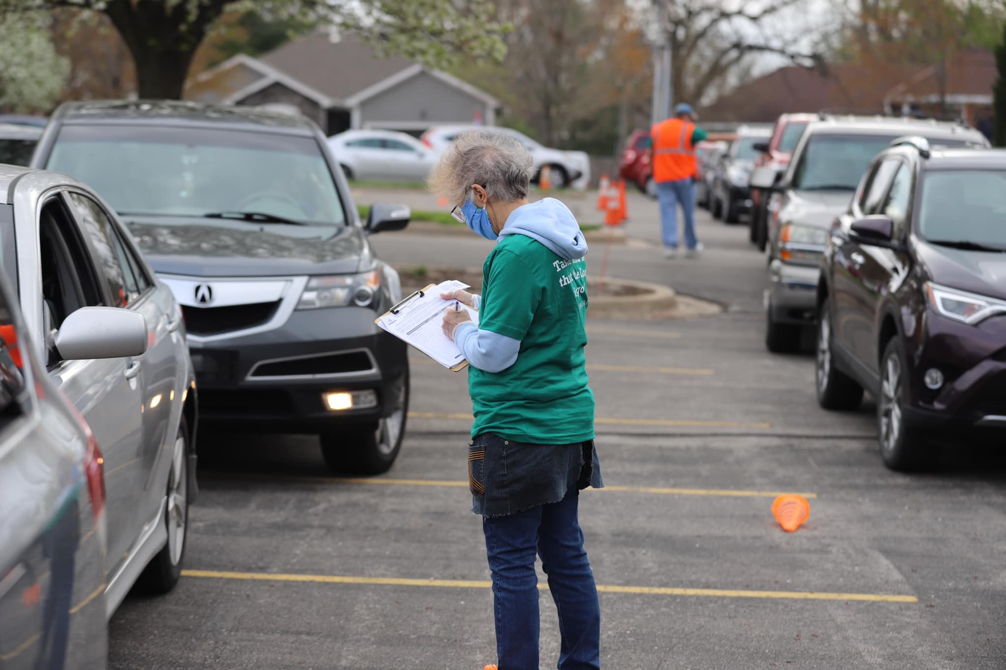 A volunteer registers a client waiting to receive food. At times, up to 600 vehicles have waited to visit the food pantry. 