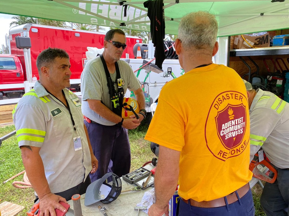 ACS DR Miami condo rescue workers talking to ACS emotional care workers