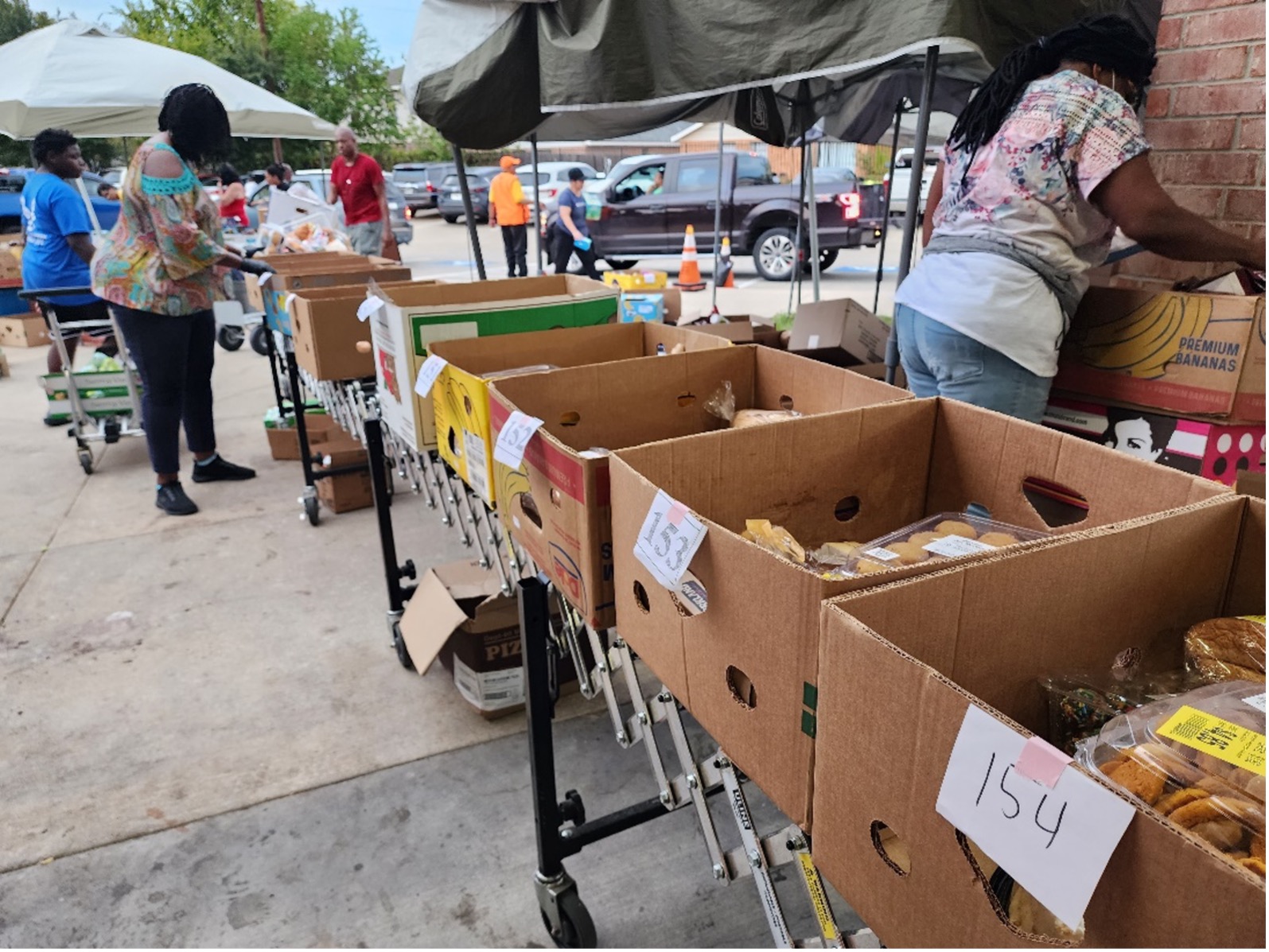 Volunteers keep the boxes rolling as they pack the food allocated for those who signed up for a box. The number on the box corresponds to the number each family has been assigned so the appropriate amount of food will be packed for each. 