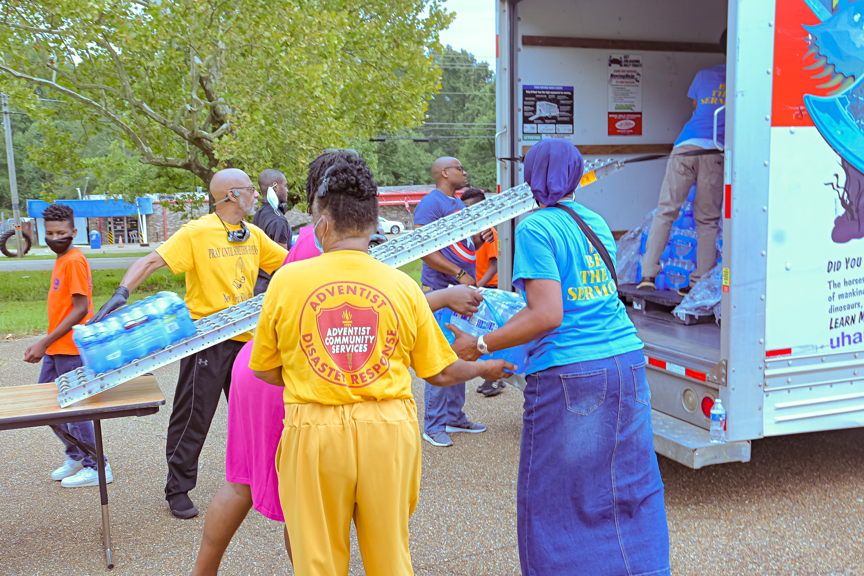 ACS volunteers from three local Adventist churches in Jackson, Mississippi, unload bottled water for distribution on Sept. 3. Photo provided by W. Derrick Lea/NAD ACS