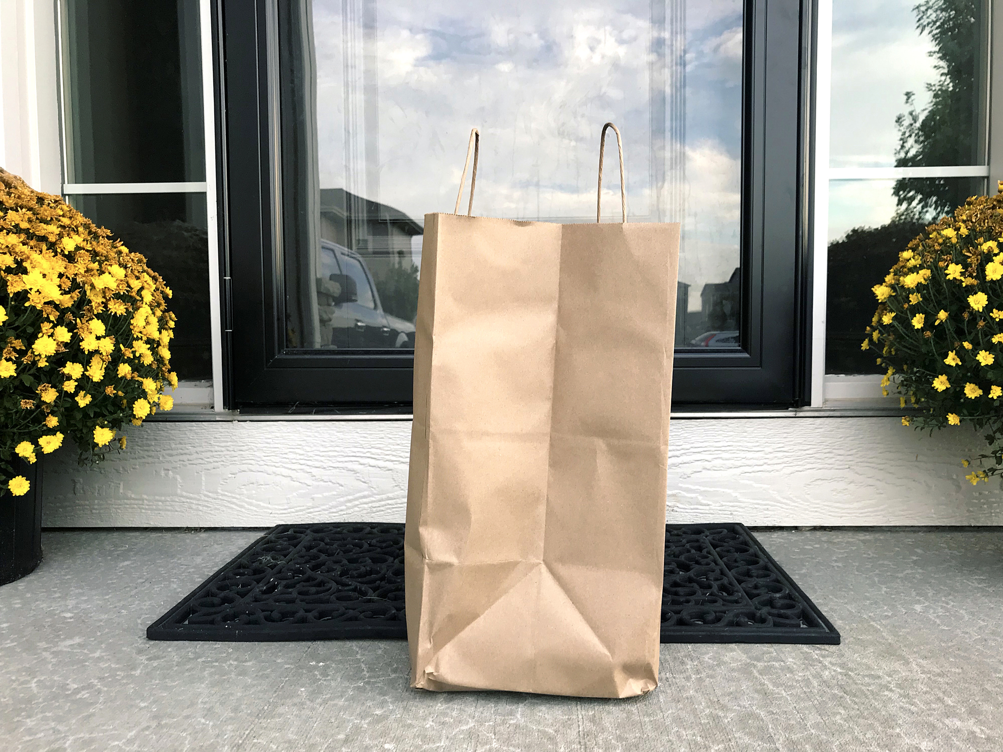 stock photo of grocery bag on door step