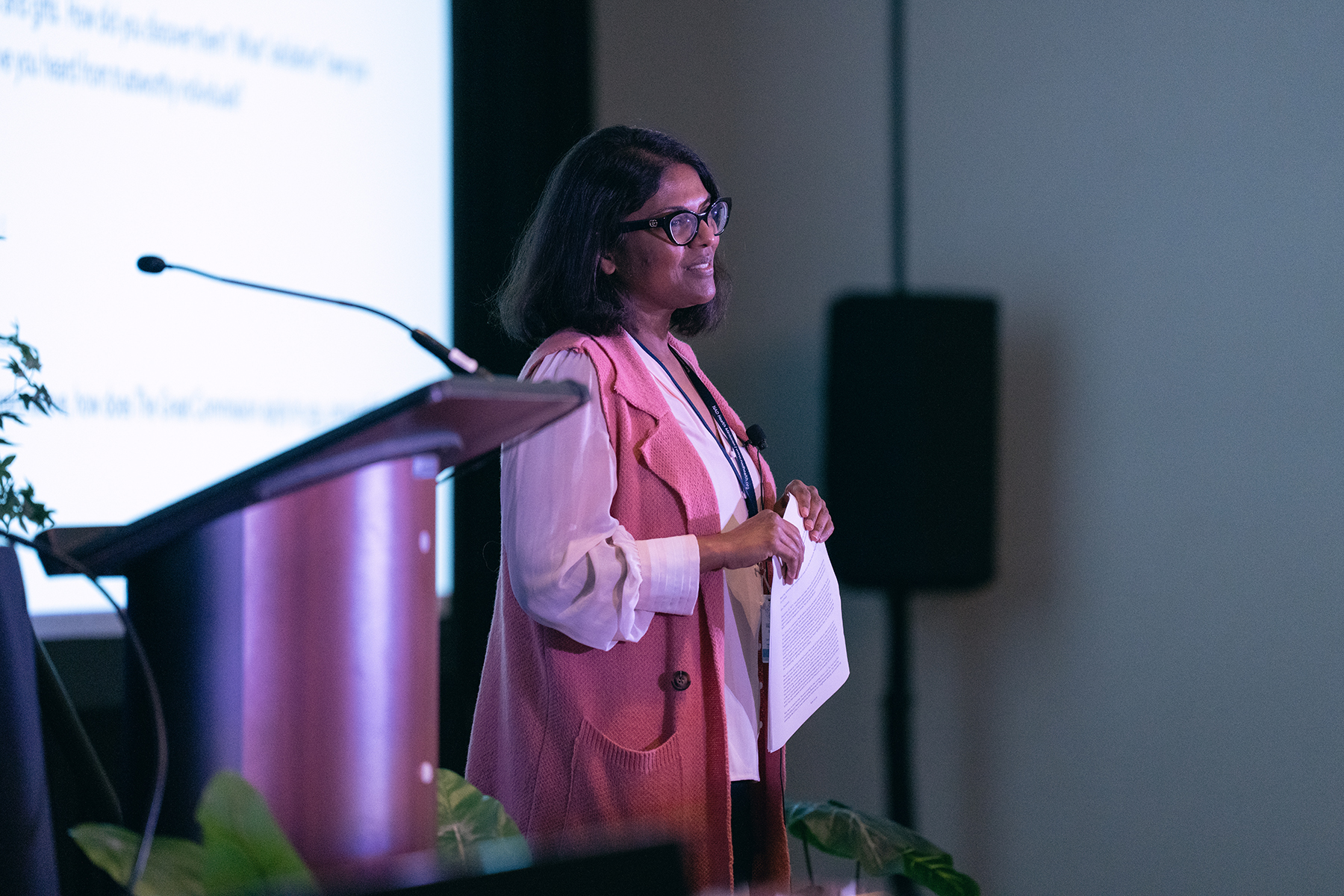 A woman speaks at a conference