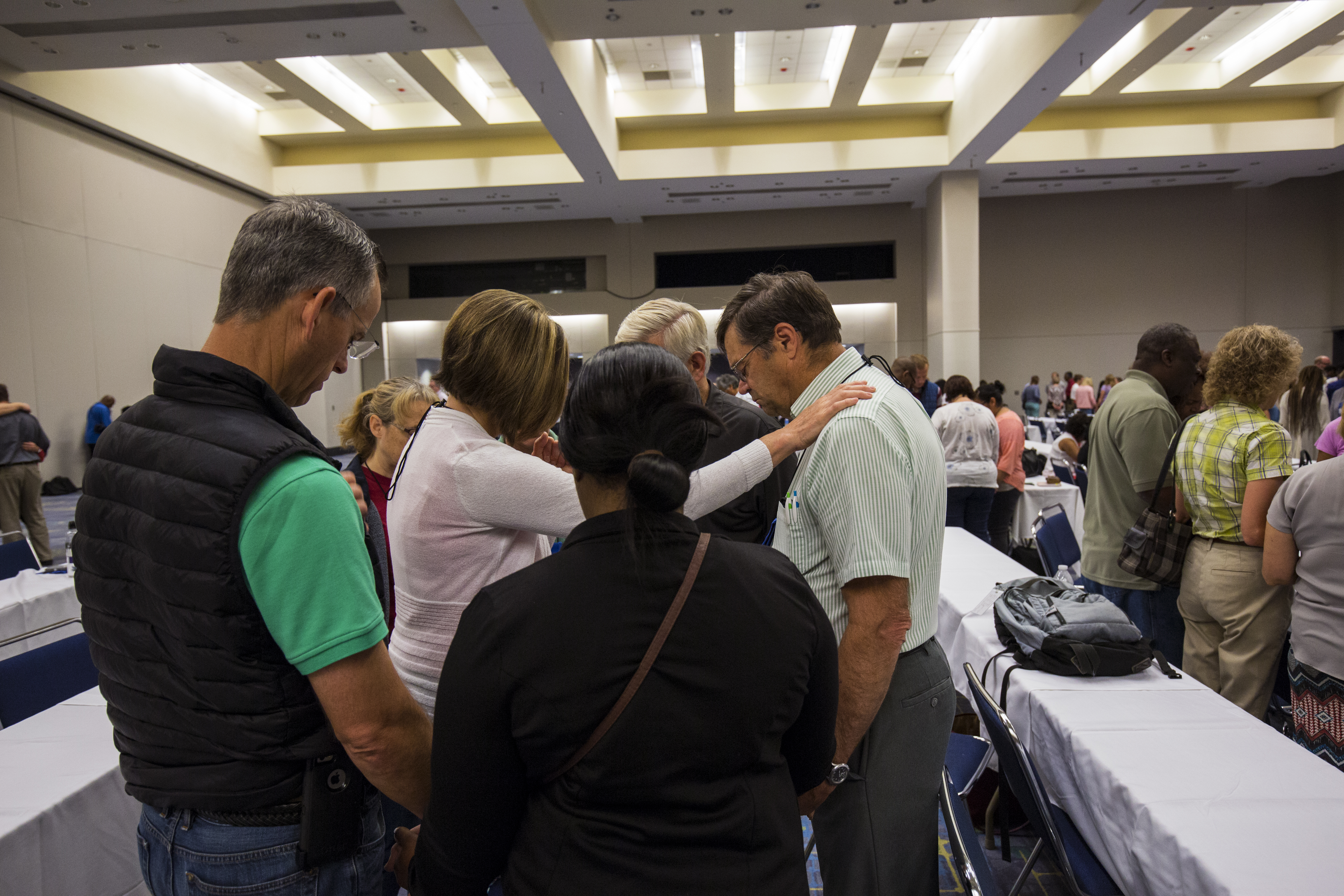 A participant of the anointing service prays over a fellow educator in her small group.