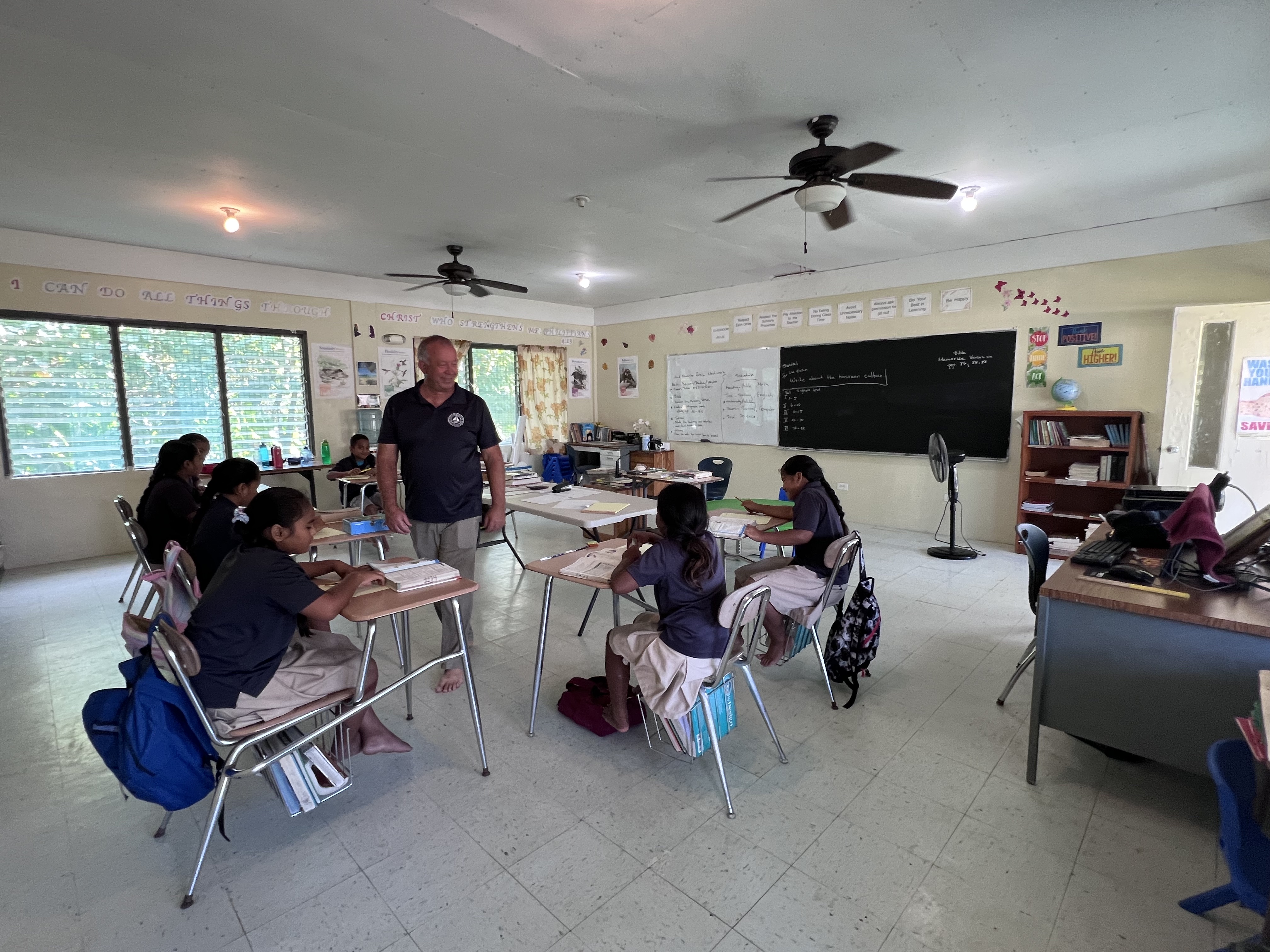 Arne Nielsen visits with students at the Adventist mission school in Kosrae, in the Guam-Micronesia Mission.