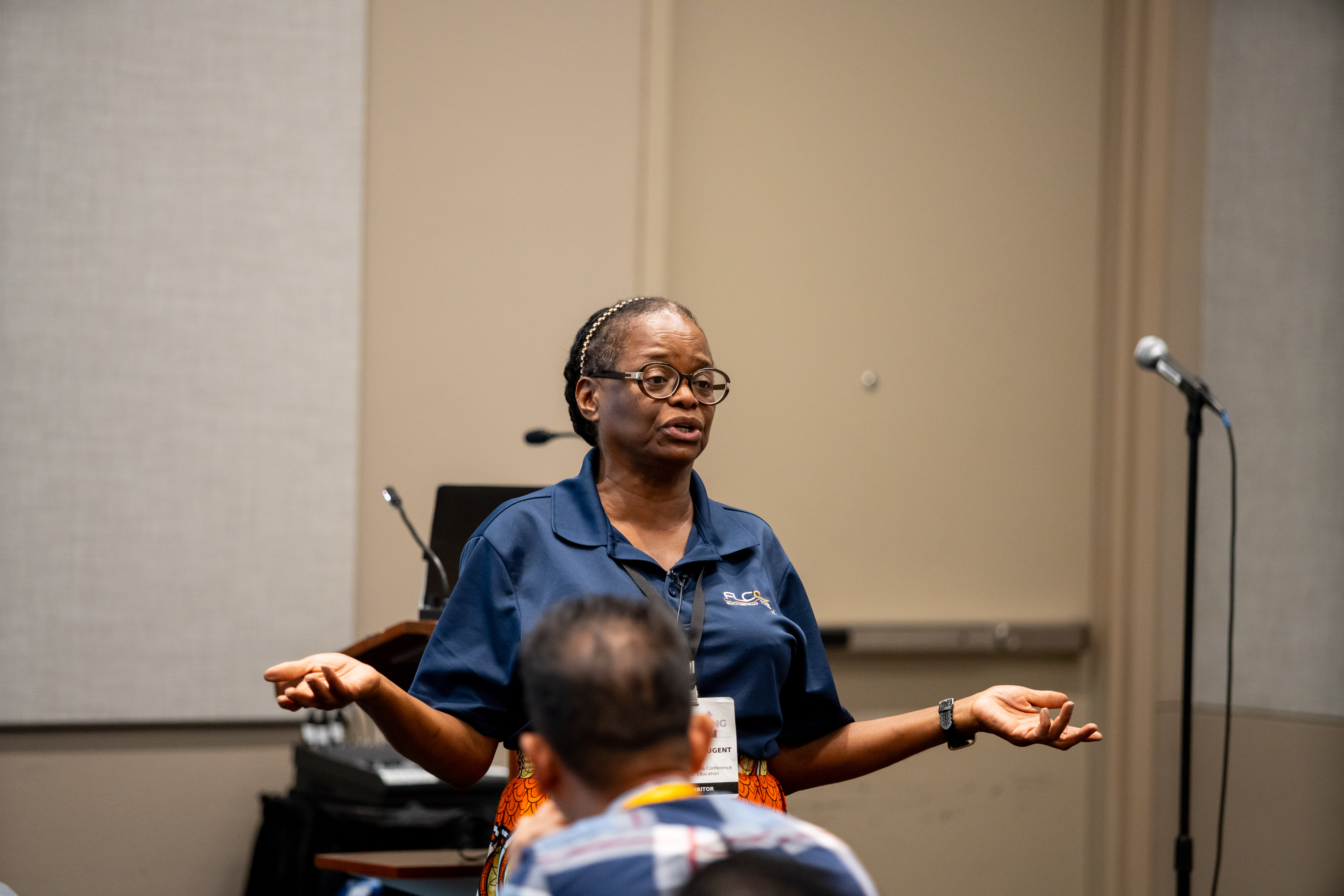 Black woman standing in front of a classroom teaching