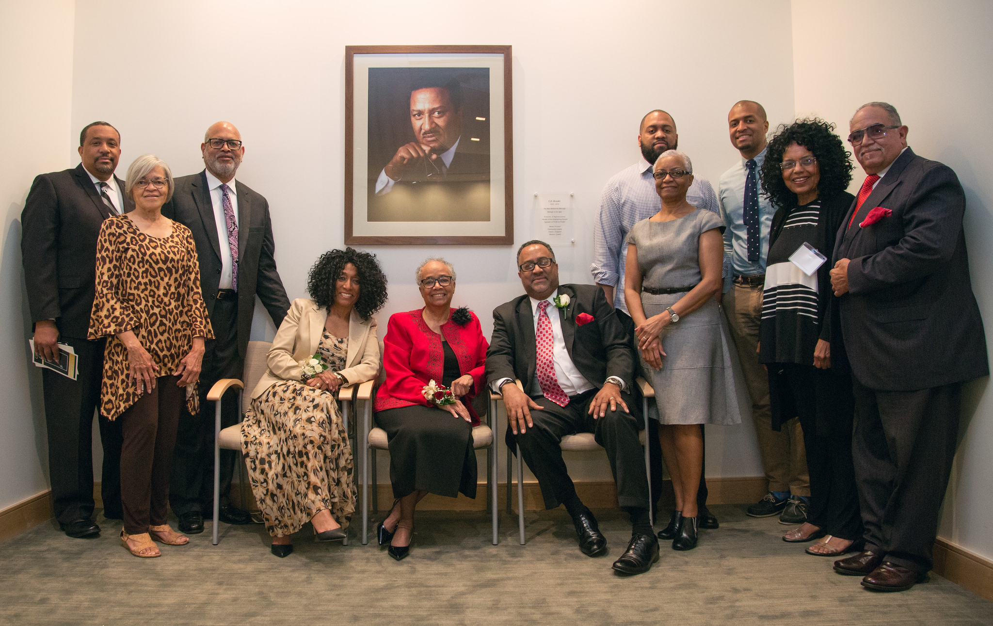 Members of the Brooks family pose under portrait of C.D. Brooks in the division headquarter's prayer chapel.