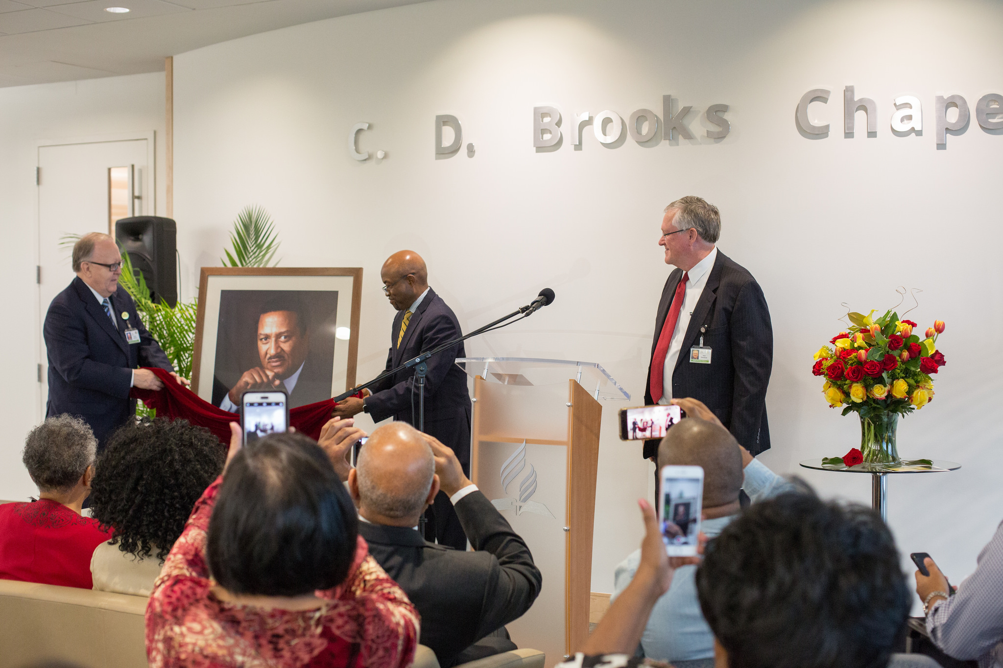 Dan Jackson, NAD president, Alex Bryant, NAD executive secretary, and Ken Denslow, executive assistant to the president of NAD, unveil a portrait during the C.D. Brooks Prayer Chapel Dedication Ceremony.