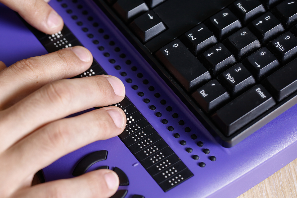 person using Braille computer keyboard