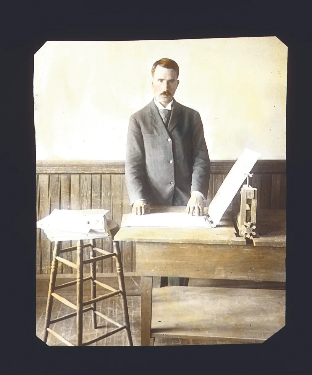 Legally blind Austin O. Wilson makes first braille magazine on a device he invented, circa 1899